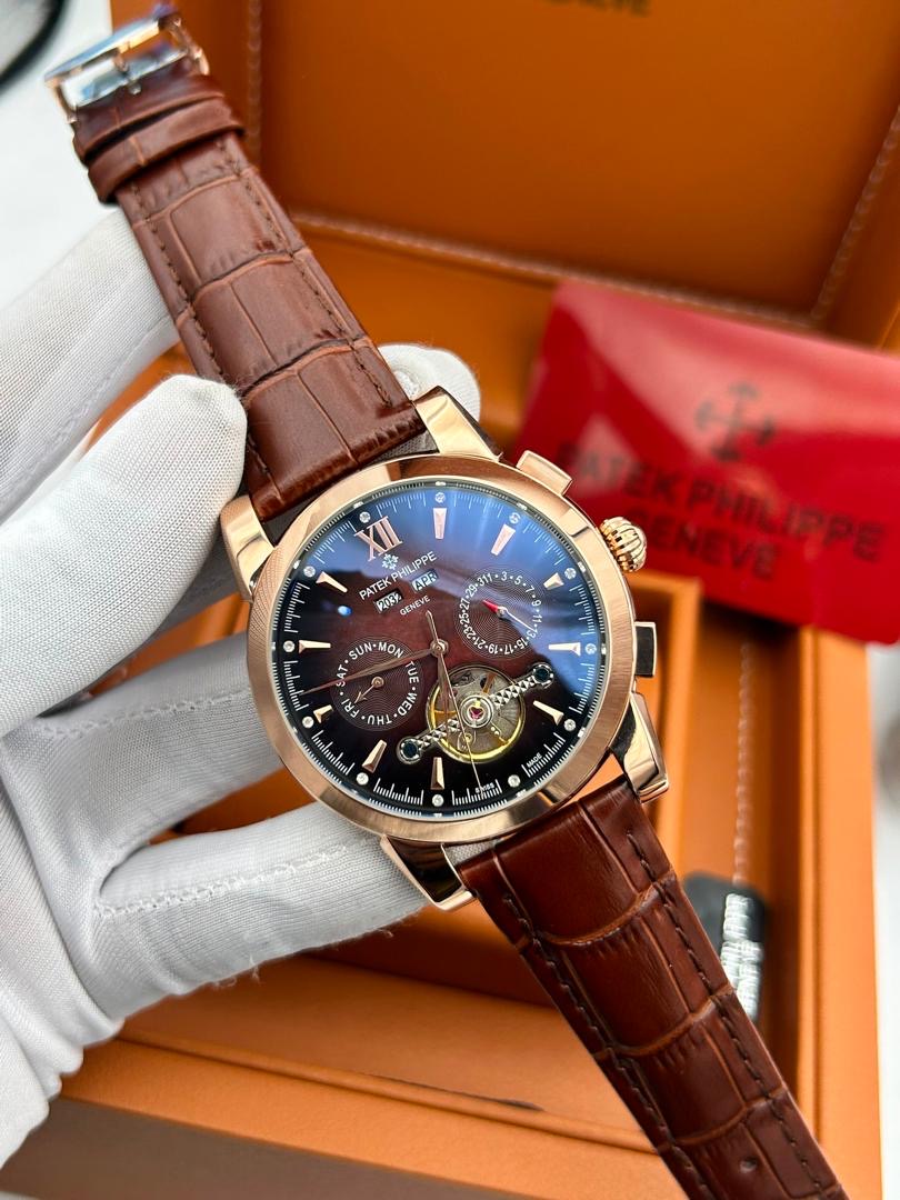 Rose gold open-work wristwatch with brown leather strap